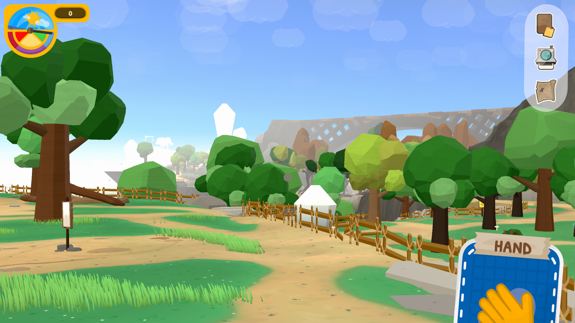First-person view of a fenced path beneath a stone bridge, with a Hand card visible